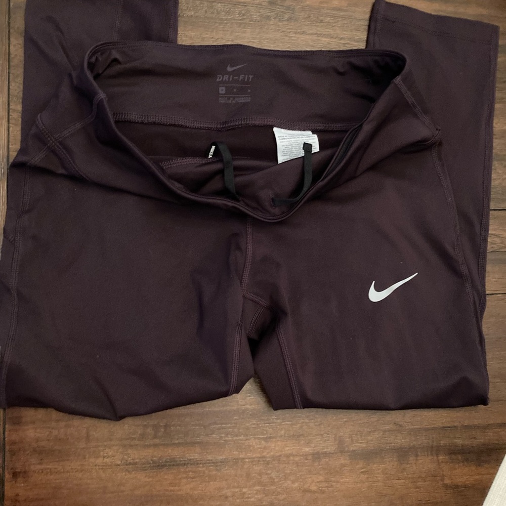 Nike size medium running leggings in a deep ruby color